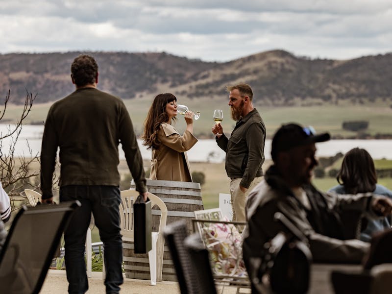 couple drinking wine with Coal River Valley in the background