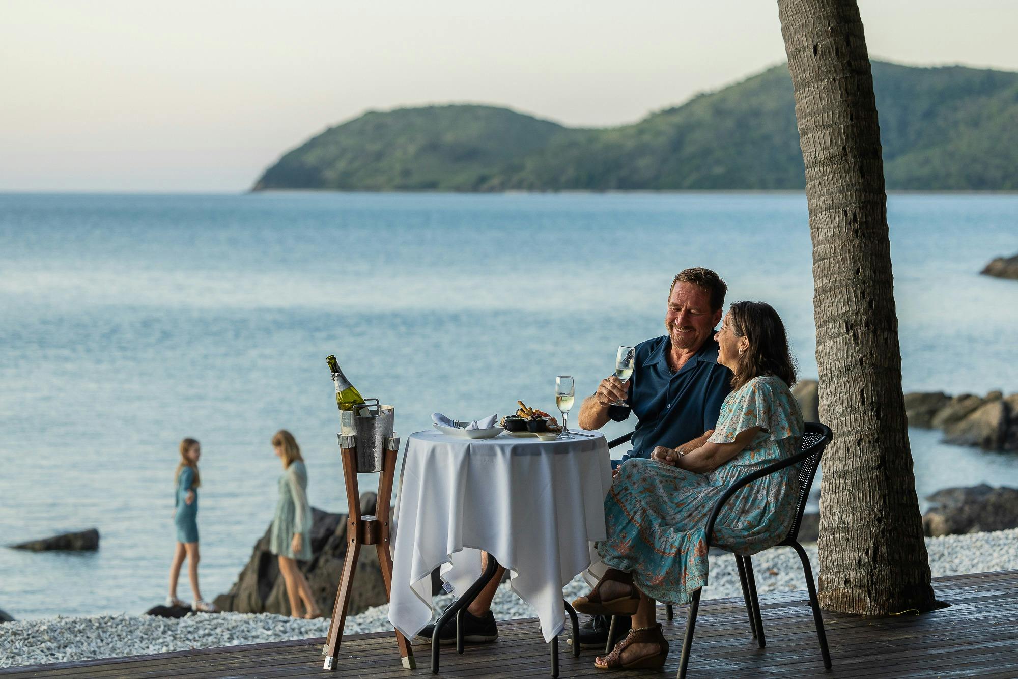 Couple enjoying afternoon canapés at Lovers Cove.