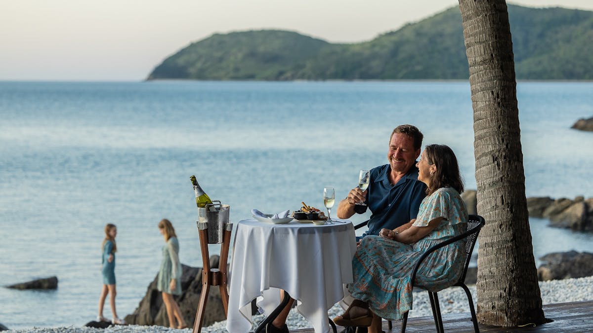 Couple enjoying afternoon canapés at Lovers Cove.