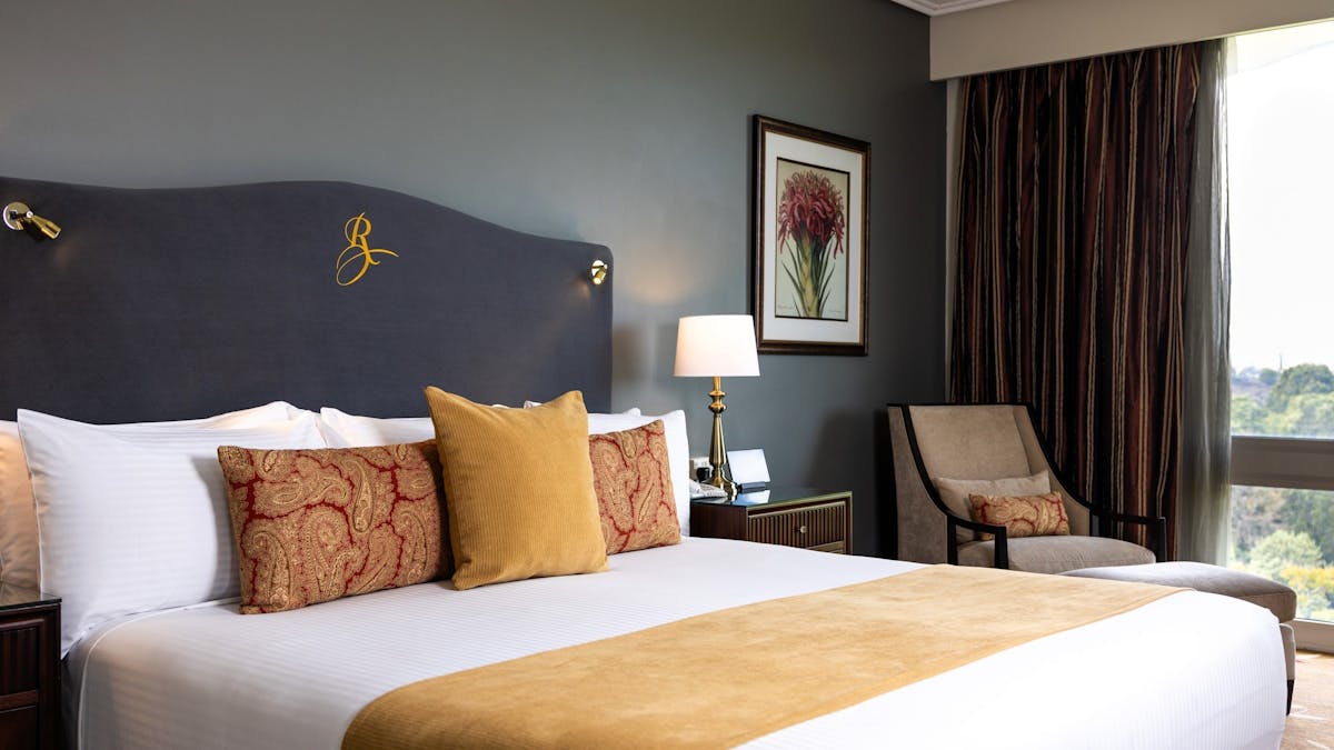 King bed with grey velvet 'Royal' headboard in Executive Suite bedroom