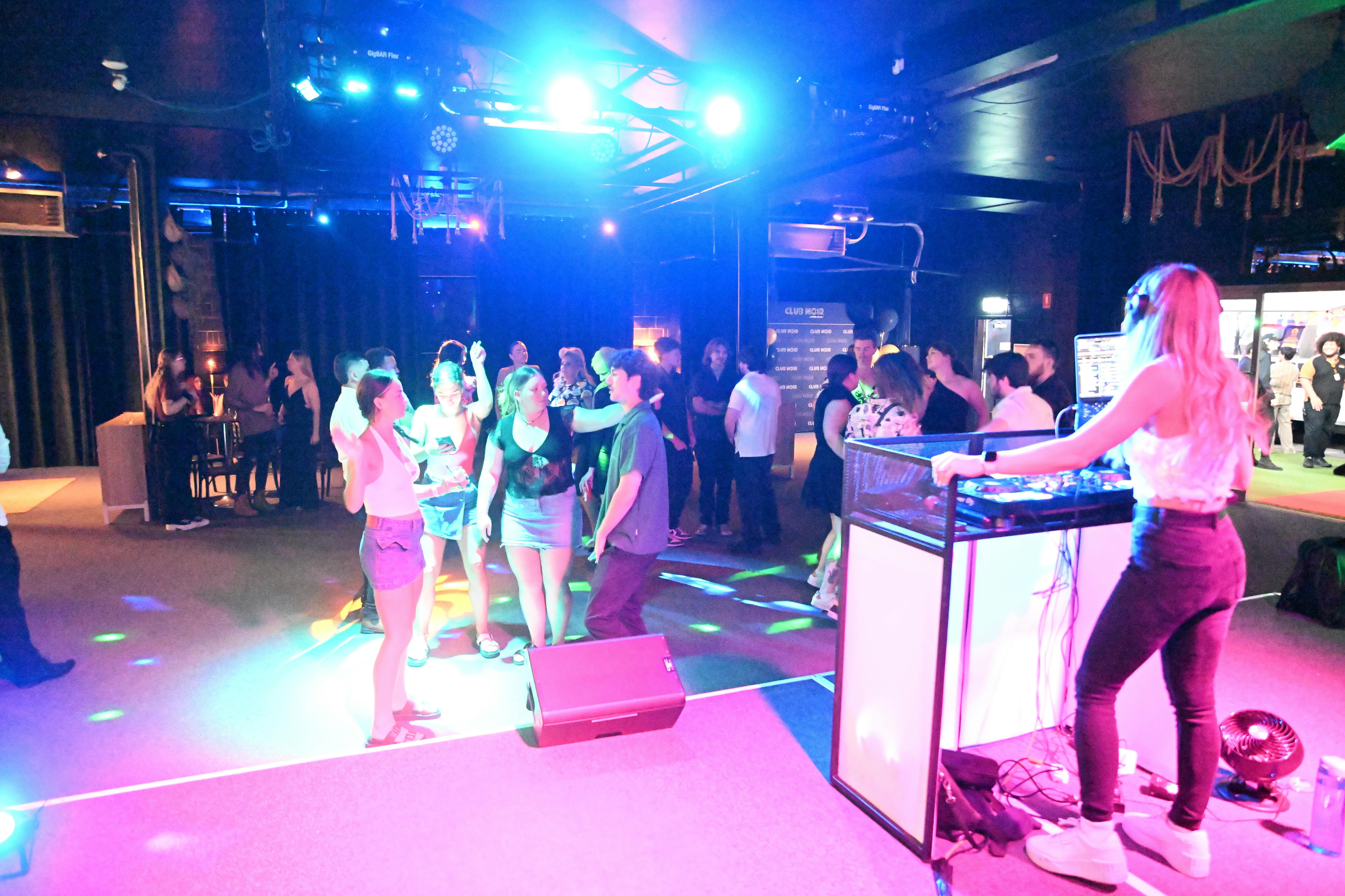 Bright lights shine on a full dancefloor on Club Noir's Night Club Night