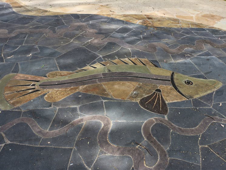 In ground mural of a Murray Cod created from slate and basalt