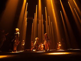 A room full of children playing in beams of golden light