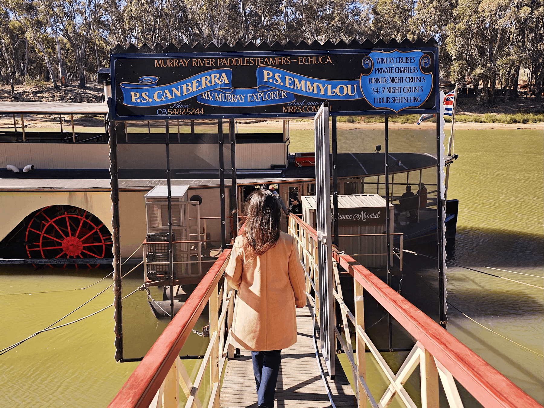 a woman boarding a river cruise, boat in the background