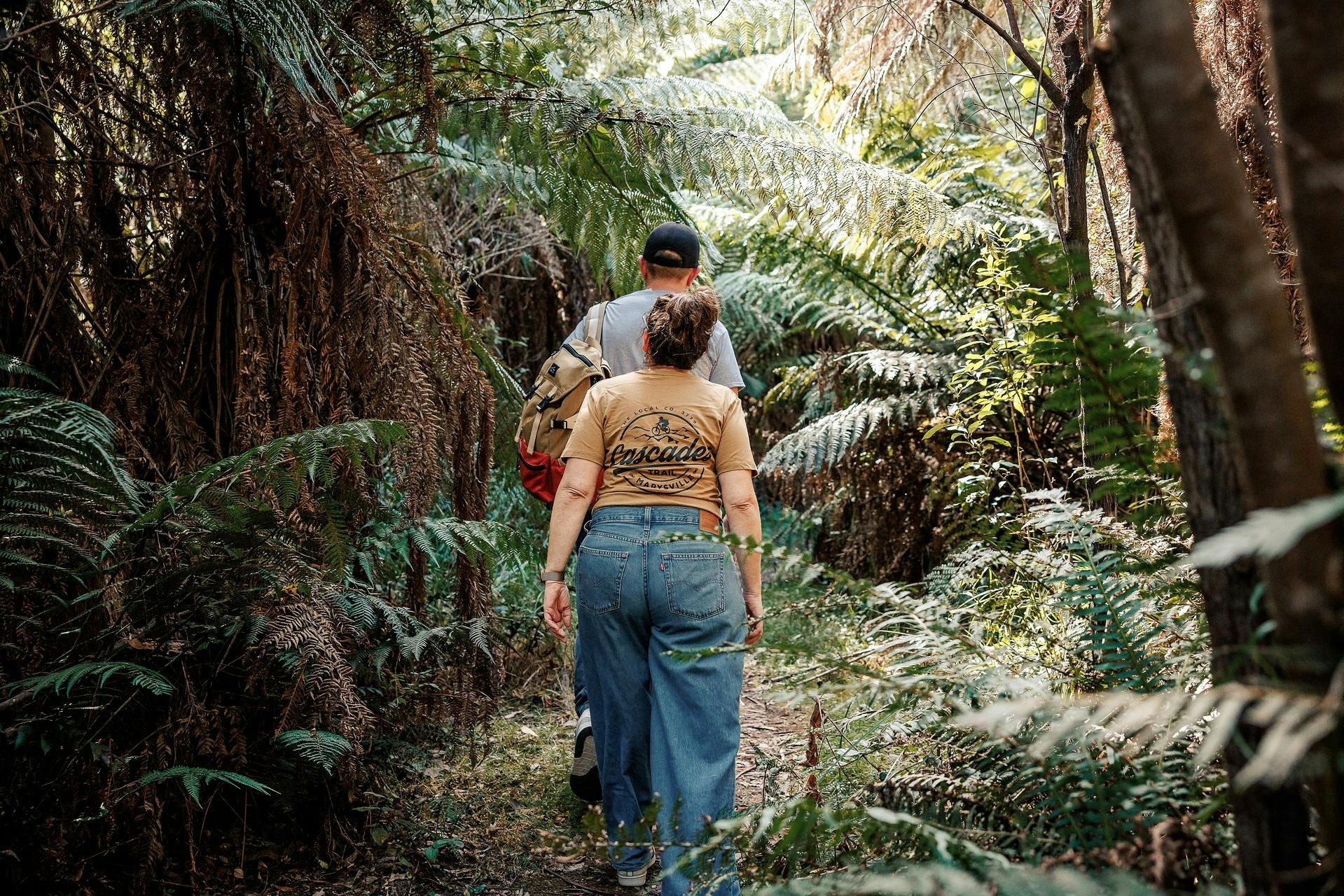A man and woman walking on a walking trail to Keppel Falls