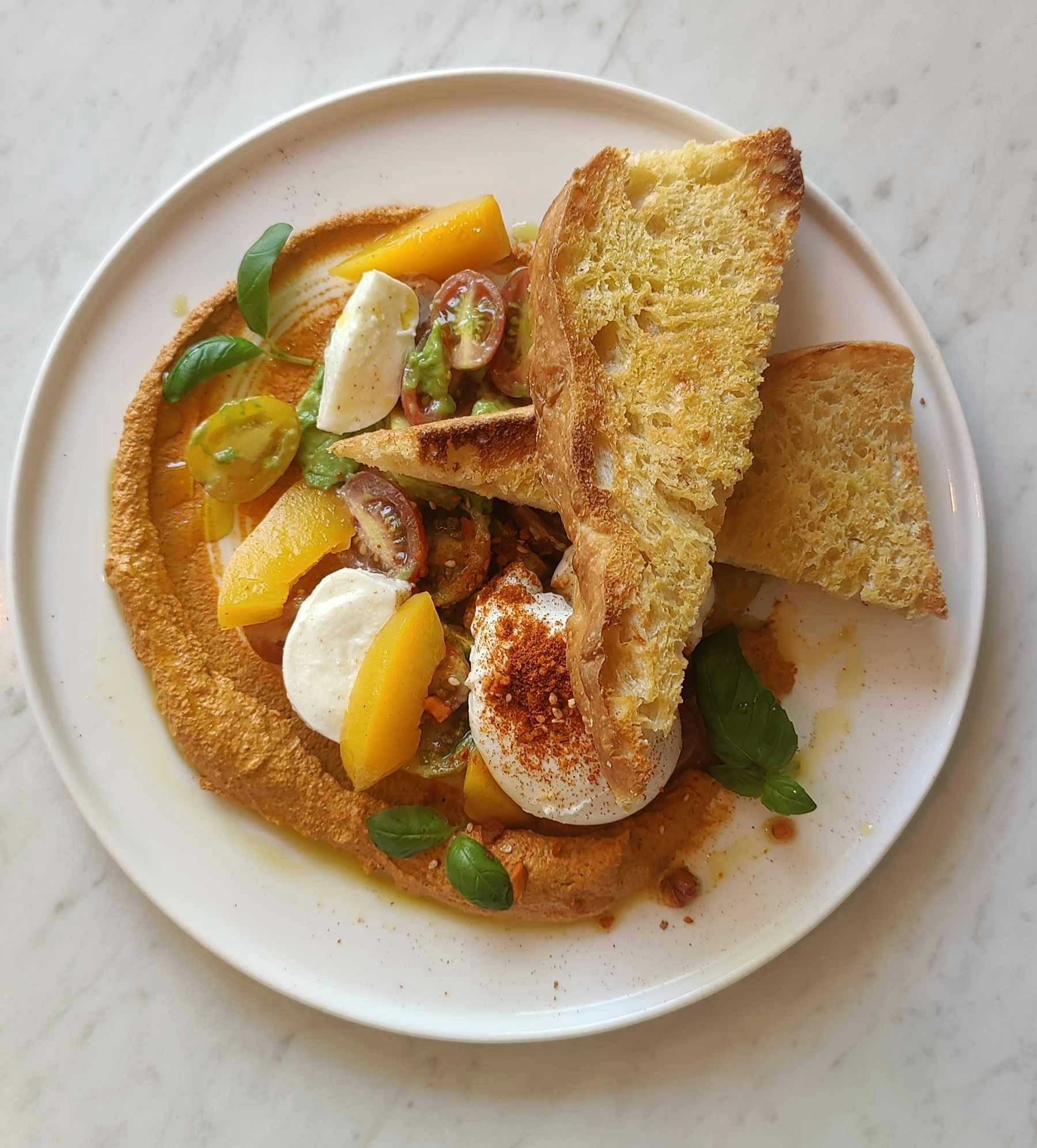 Focaccia, peach, heirloom tomato, buffalo mozzarella, egg, basil, romesco, olive oil