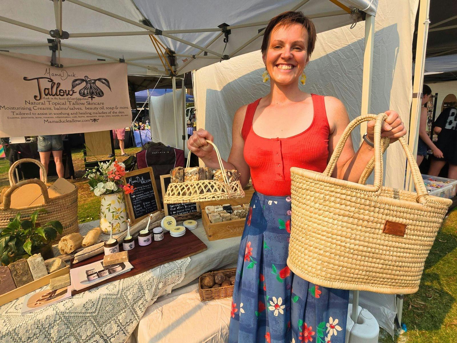 Market stall selling tallow with lady holding market bags