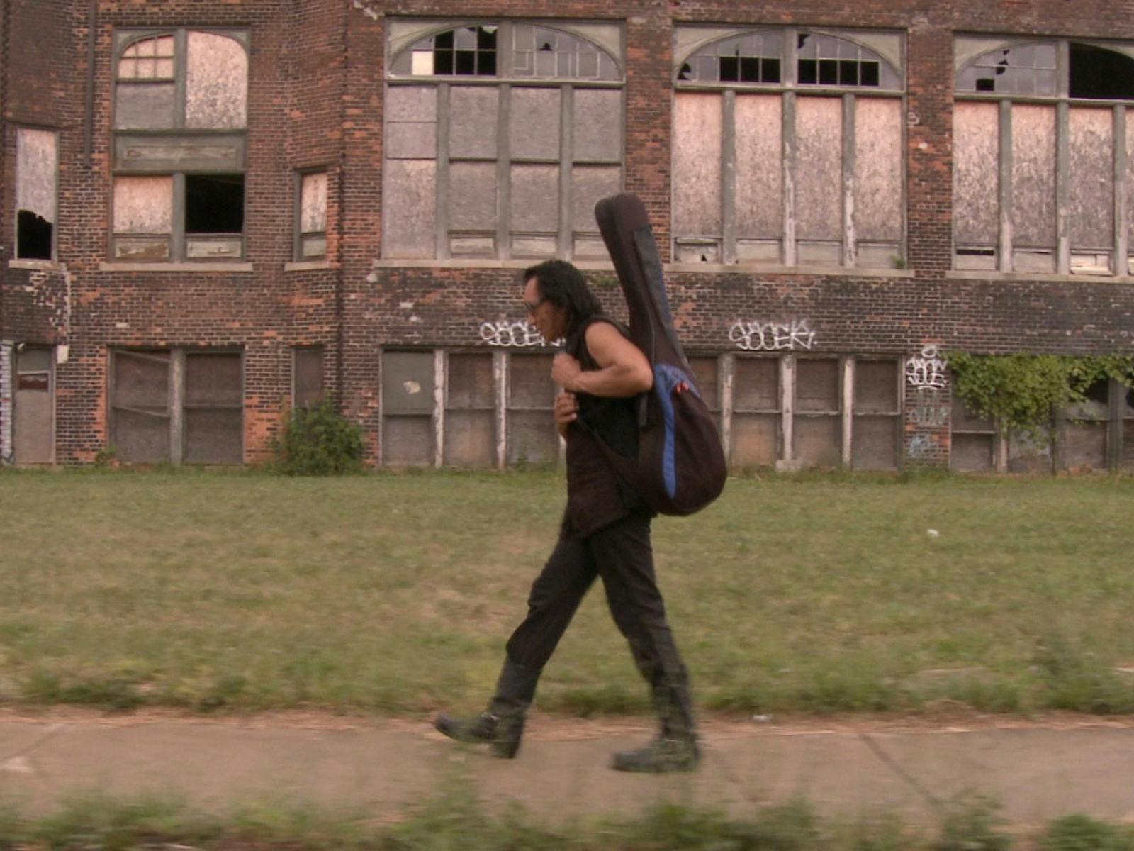 Man walking with guitar