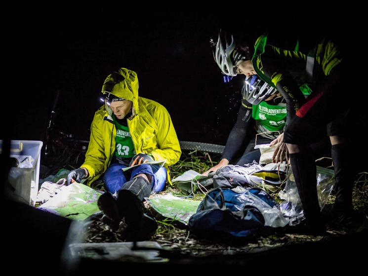A team planning their route in the dark
