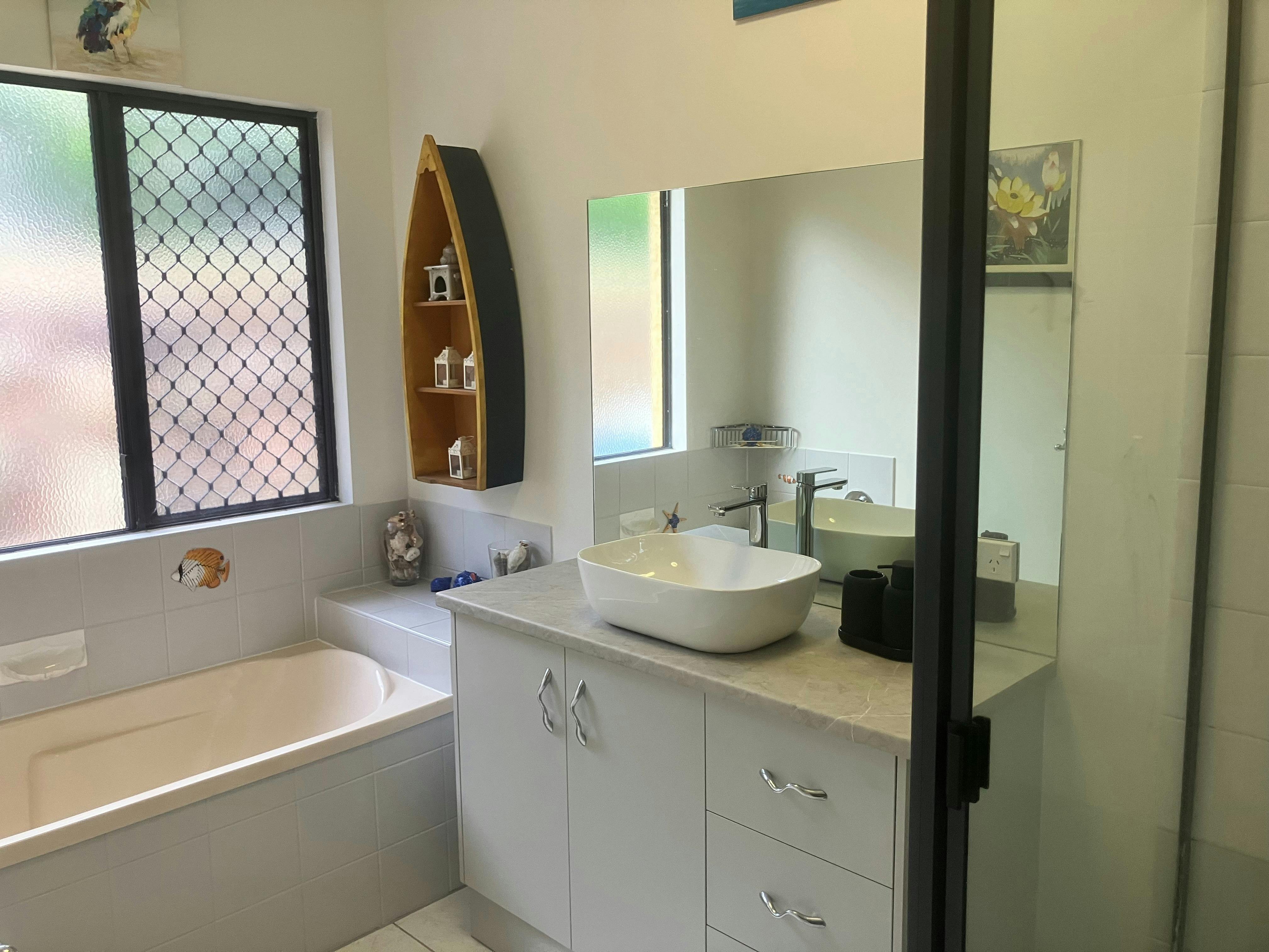 Bathroom with shower and bathtub.