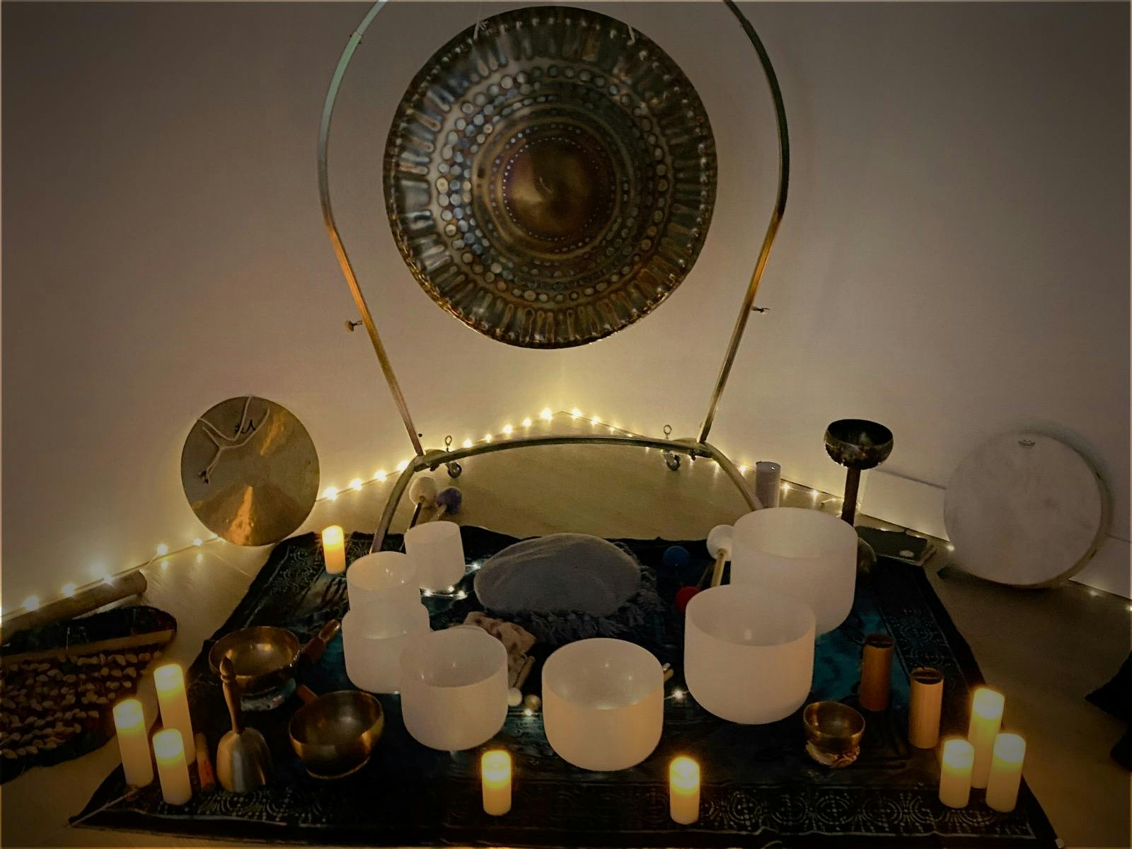 Instruments including sining bowls and gongs set up for a sound bath.