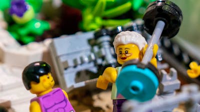 LEGO® minifigure in gym lifting weight in RELICS exhibit
