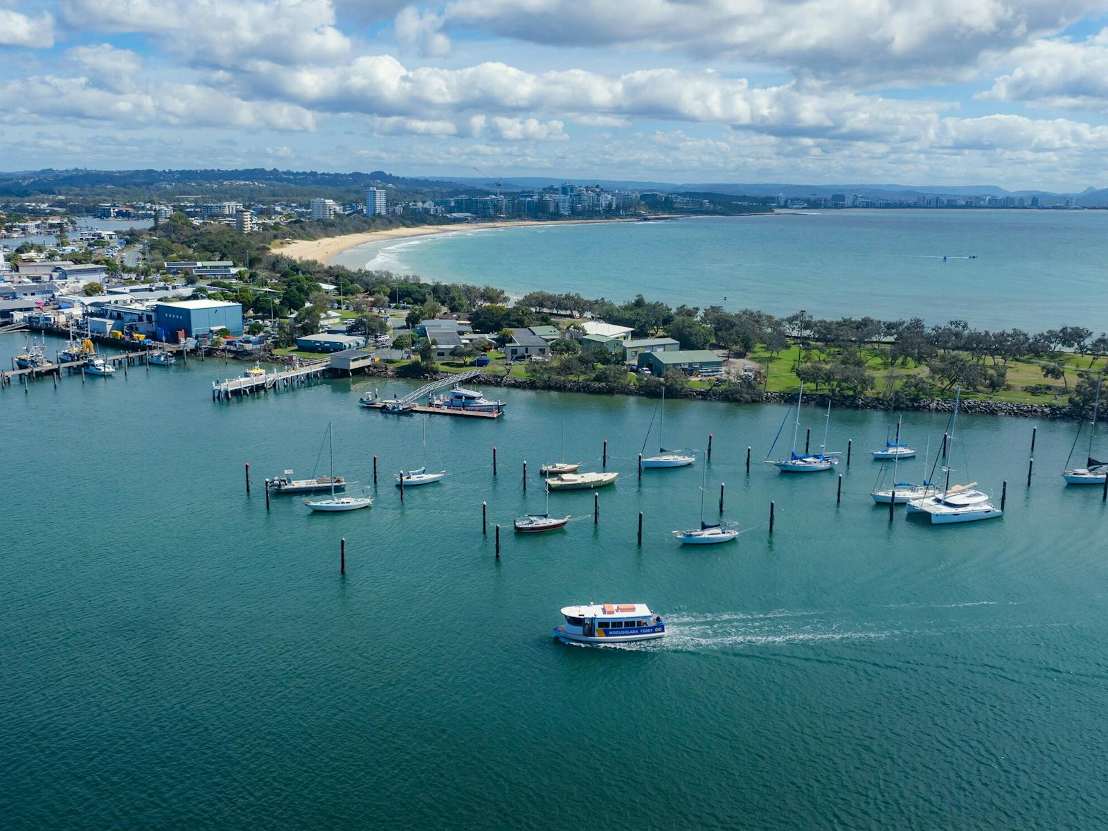 An aerial image of the Mooloolaba Ferry on the water leaving Mooloolaba Beach. An aerial image of the Mooloolaba Ferry on the water leaving Mooloolaba Beach.