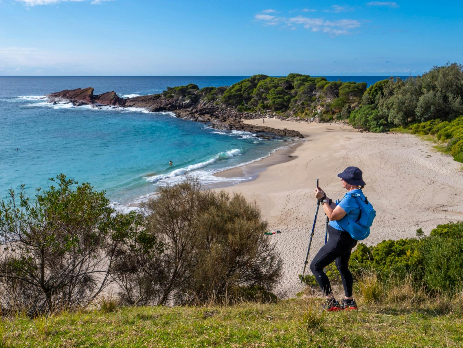 Our guest pausing to snap a shot of the stunning Mowaly Beach on the Light to Light trail.