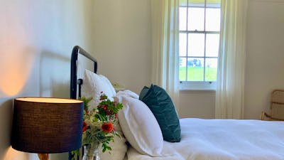 Charming lamps and beautiful Australian artwork feature in this bedroom.