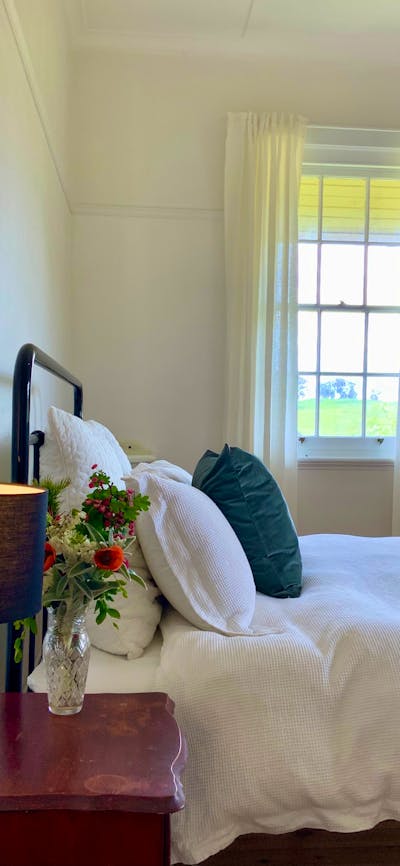 Charming lamps and beautiful Australian artwork feature in this bedroom.