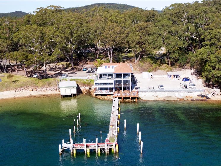 Waterfront building with jetty and car park looking out over the bay