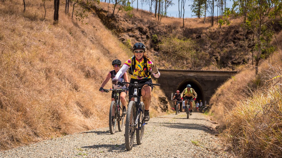 Happy bike riders after riding through Heritage-listed Yimbun Tunnel