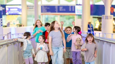 A group of children going up the ramp at Questacon