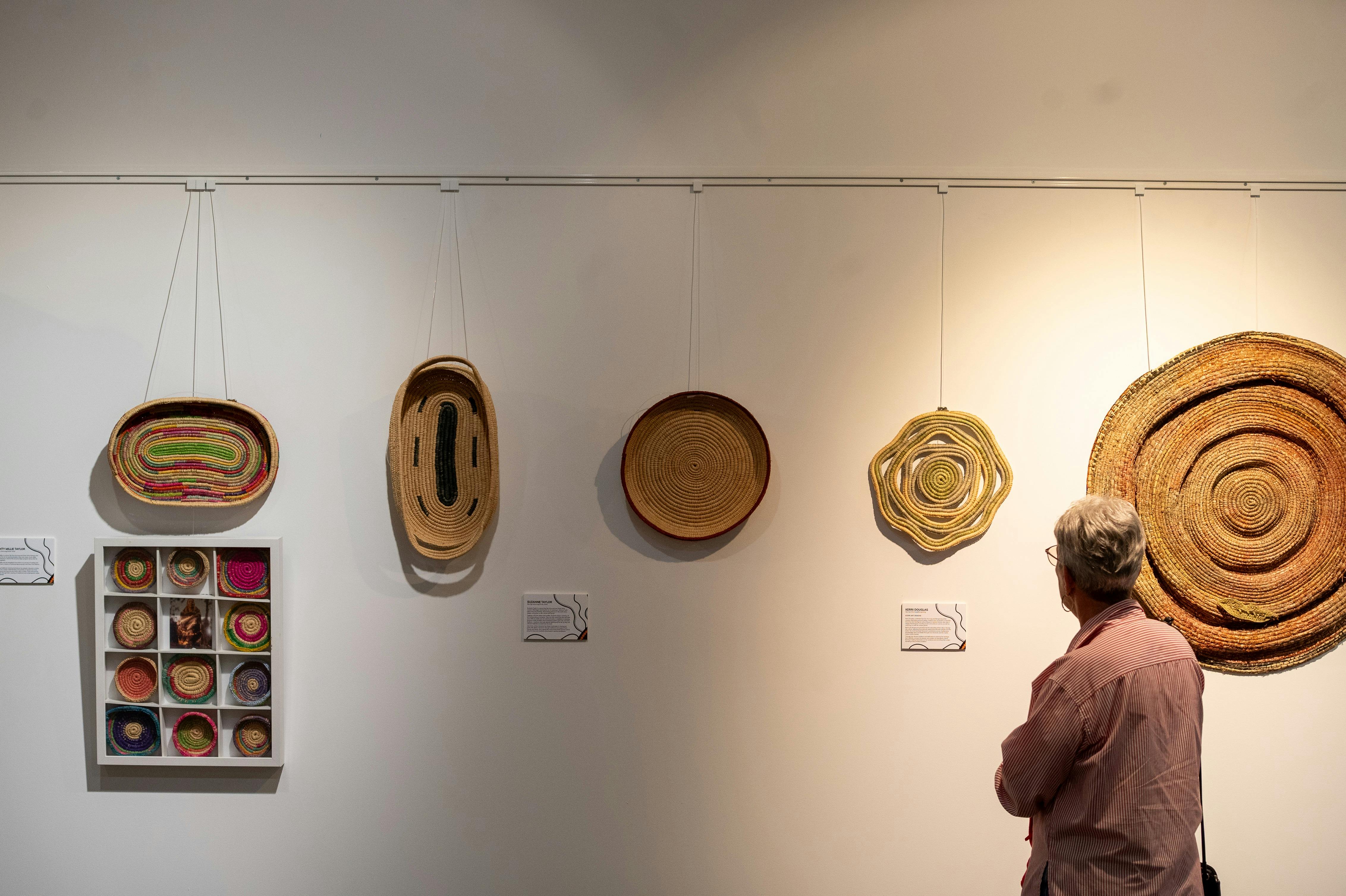 Gallery space at DUMAWUL arts hub with weavings on the wall