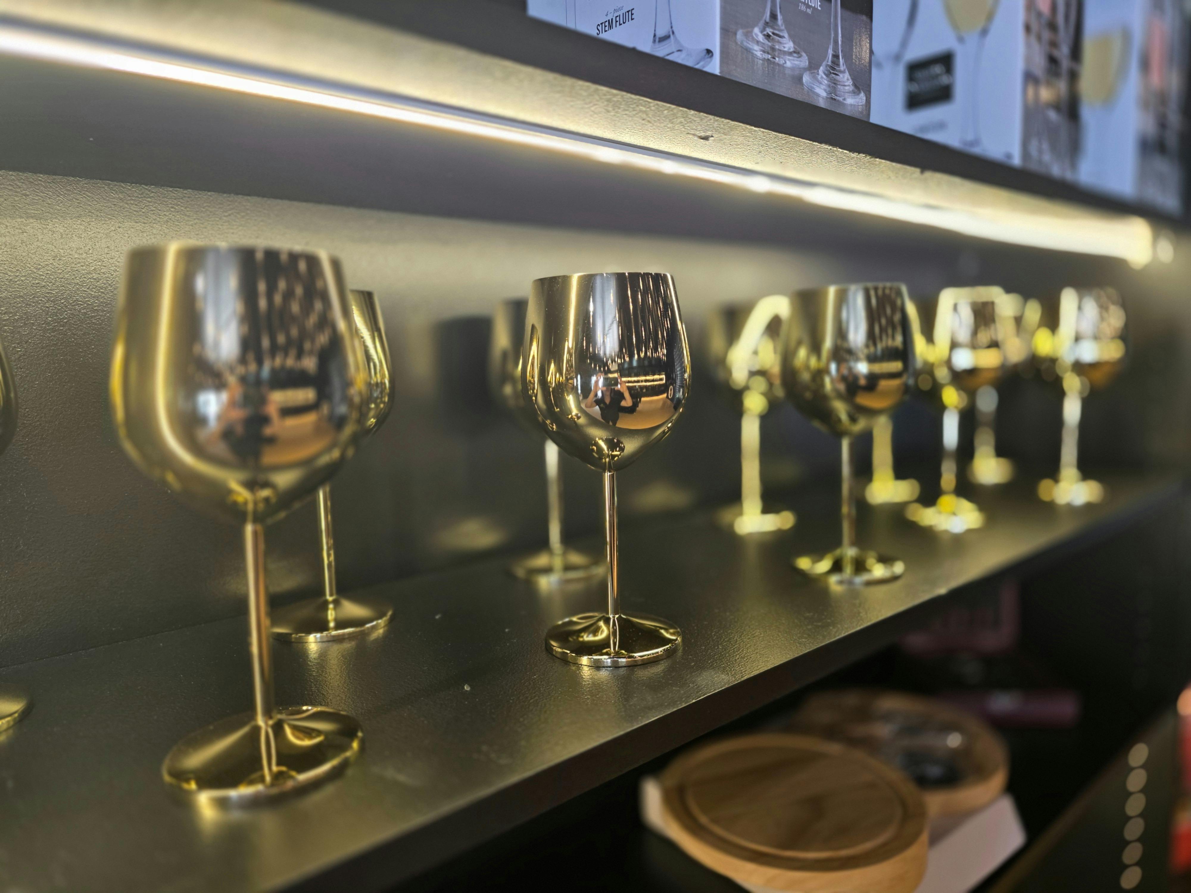 Retail shelving with curated souvenirs and wine accessories.