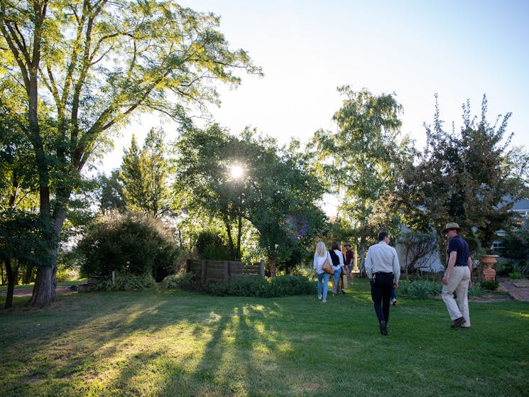 A tour group walks through the gardens