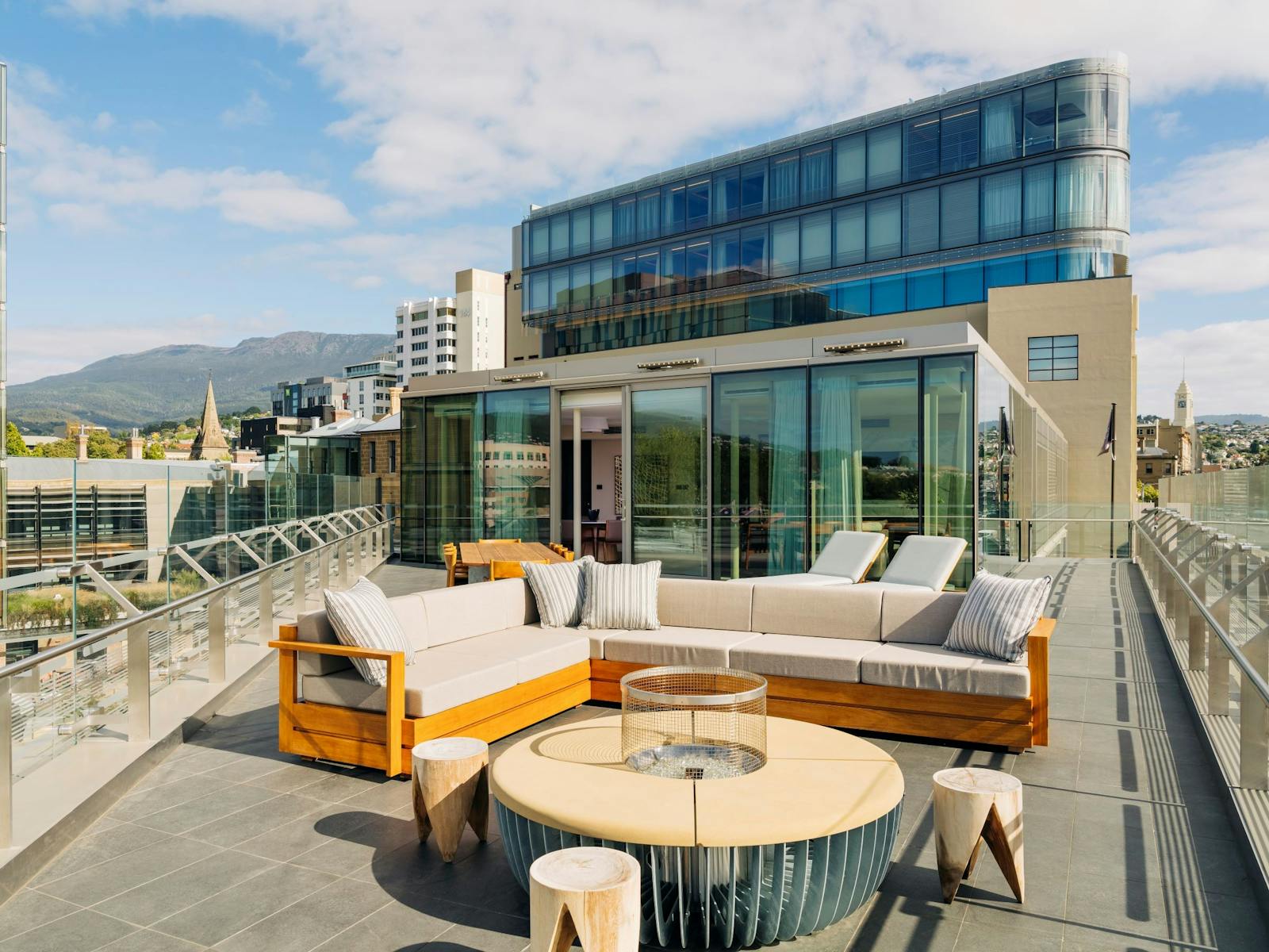 Looking across the outdoor terrace to the Aurora Suite, with kunanyi/Mt Wellington behind