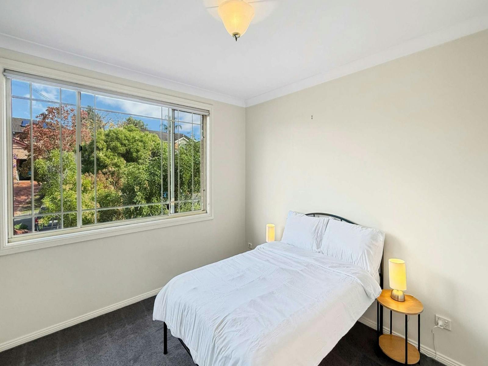 Sunny bedroom overlooking greenery