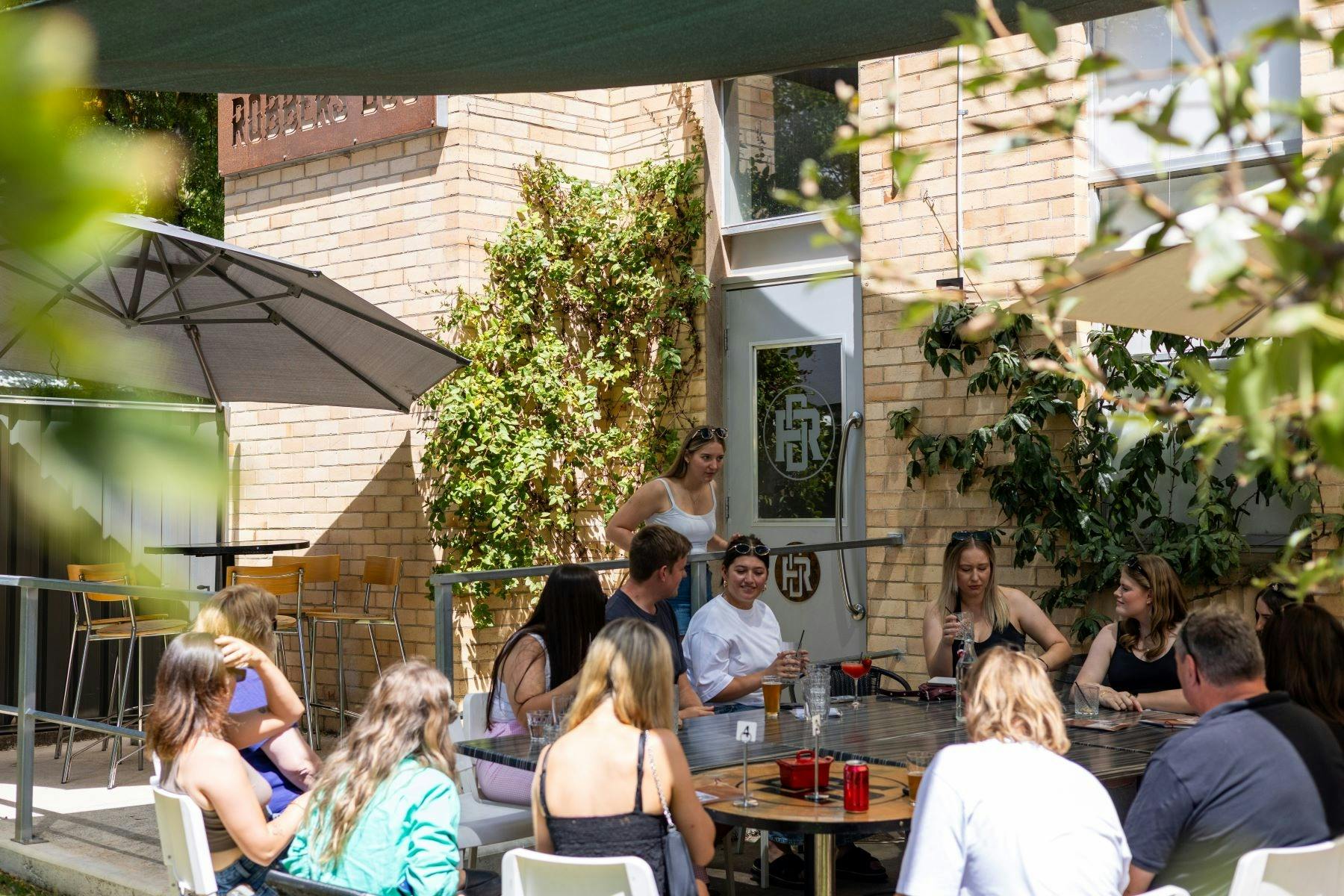 Relax with a refreshing cocktail in the sunny outdoor beer garden at Robbers Dog Distillery today