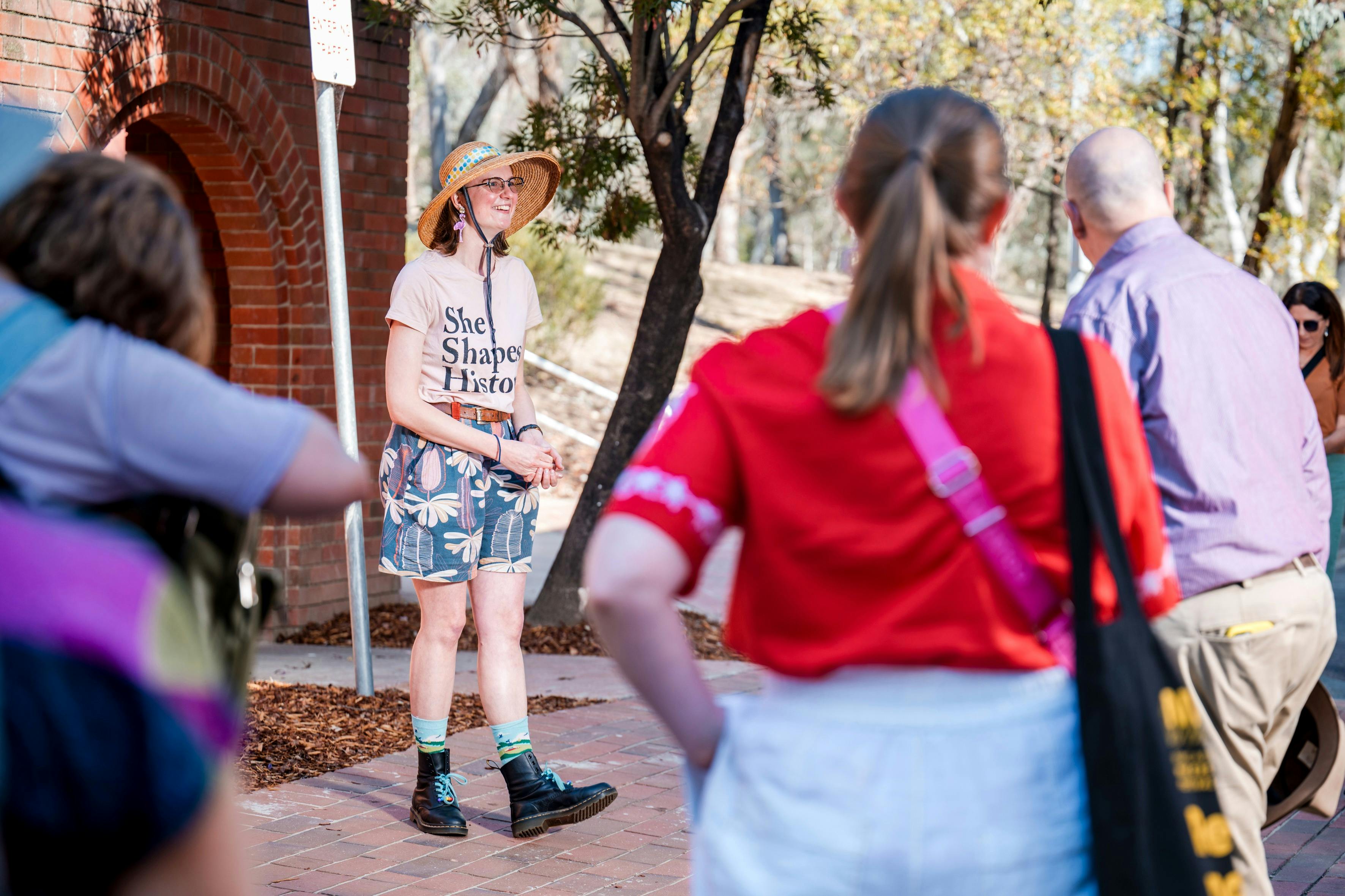 She Shapes History tour guide presenting to the group of engaged guests