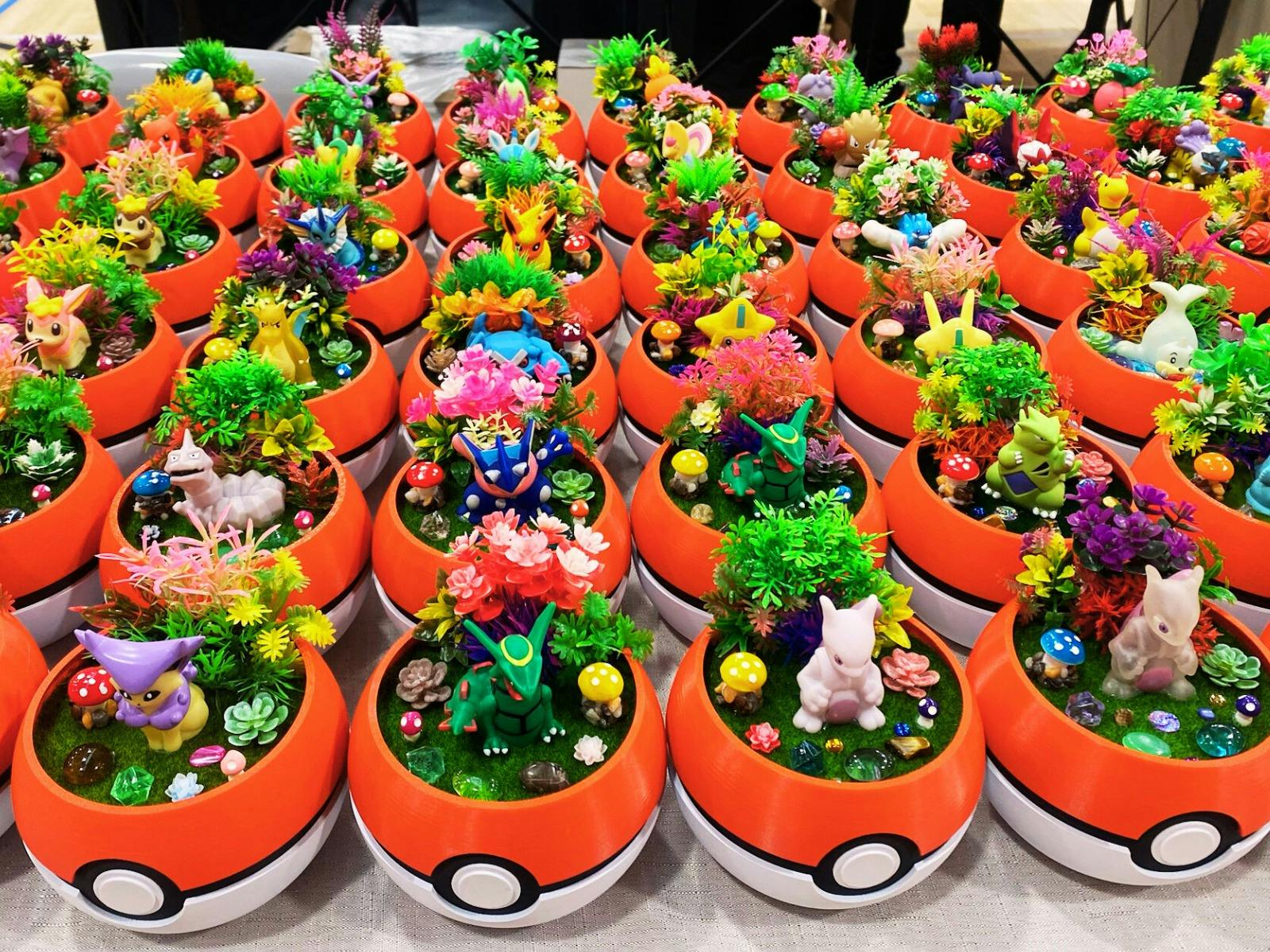 Pokeball pots with terranium set up of Pokemon and greenery