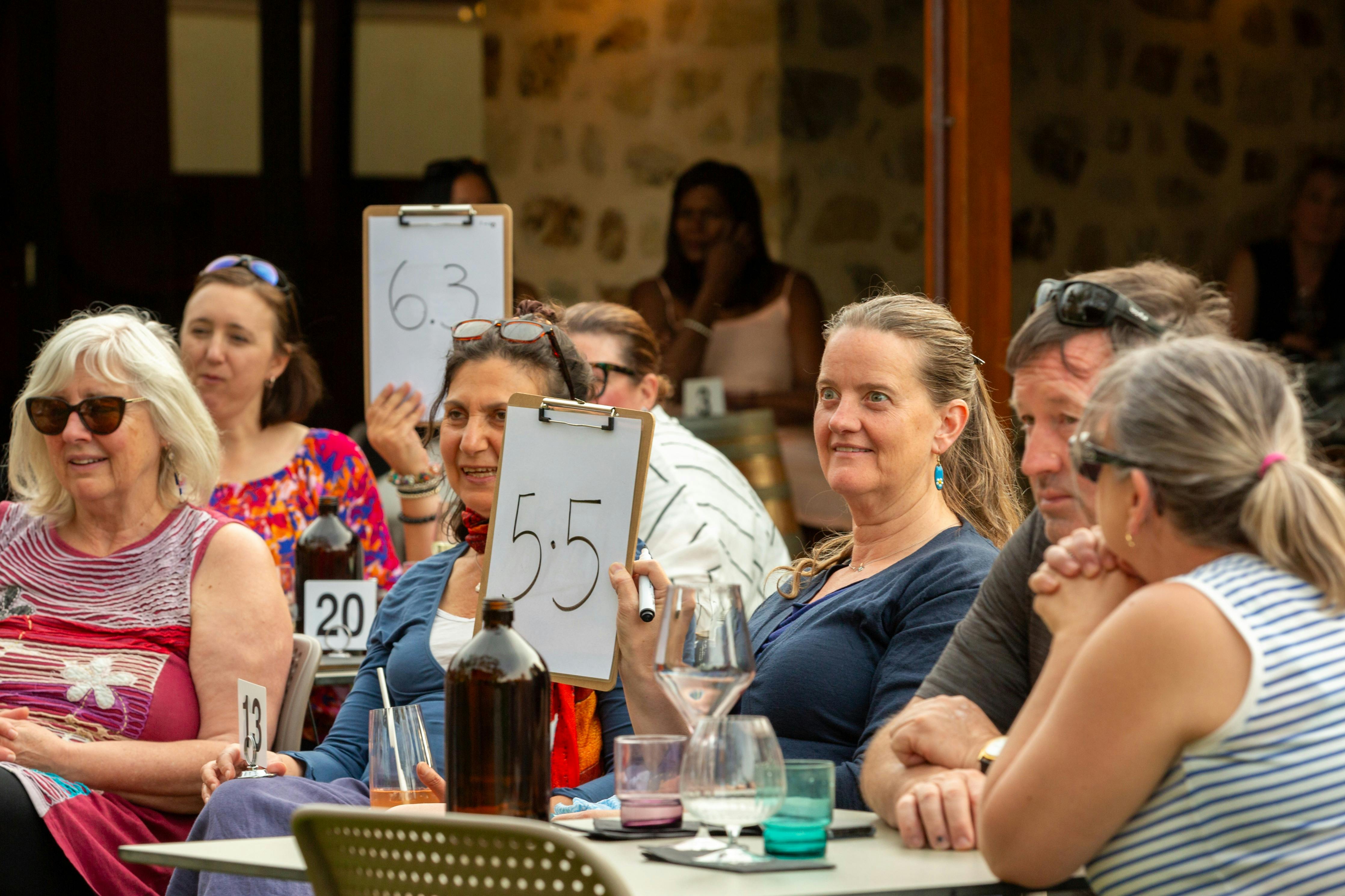 Groupd of people with two people holding up score cards