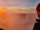 A hiker mesmerised by a setting sun