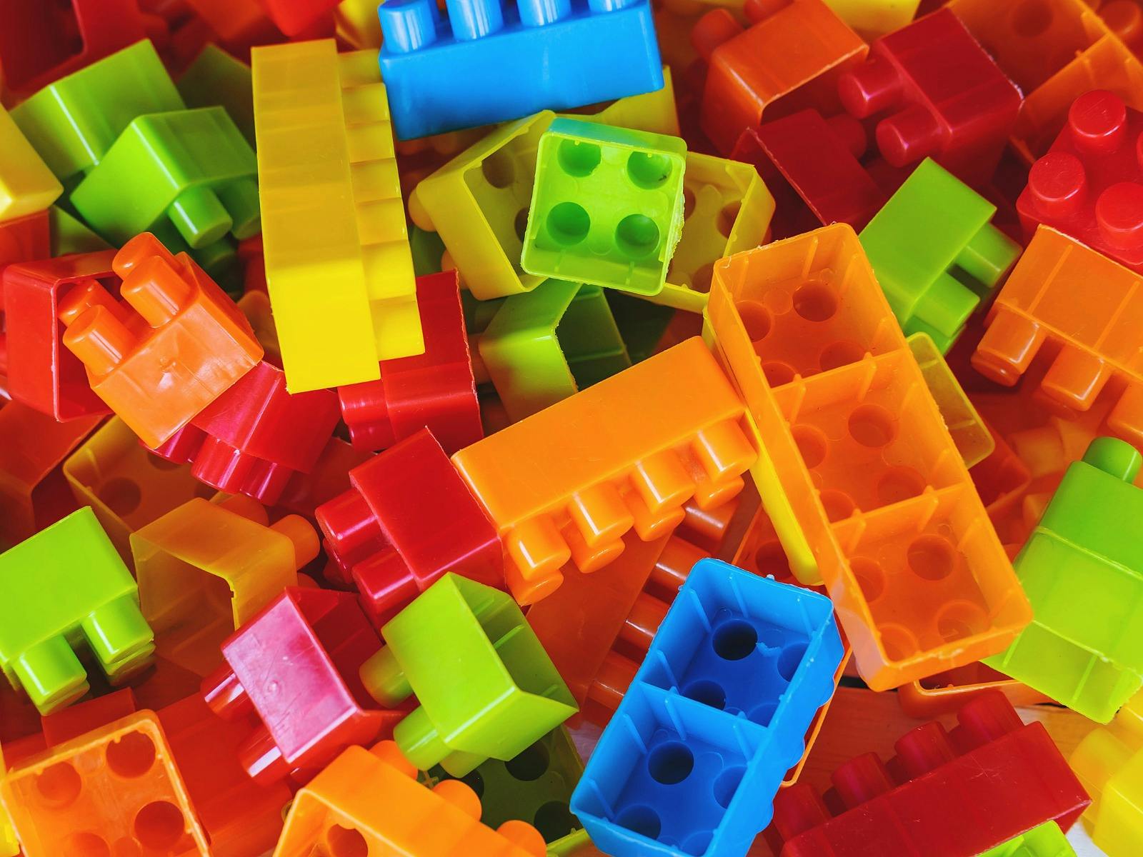 A pile of rainbow coloured building blocks