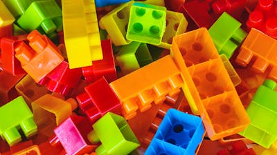 A pile of rainbow coloured building blocks