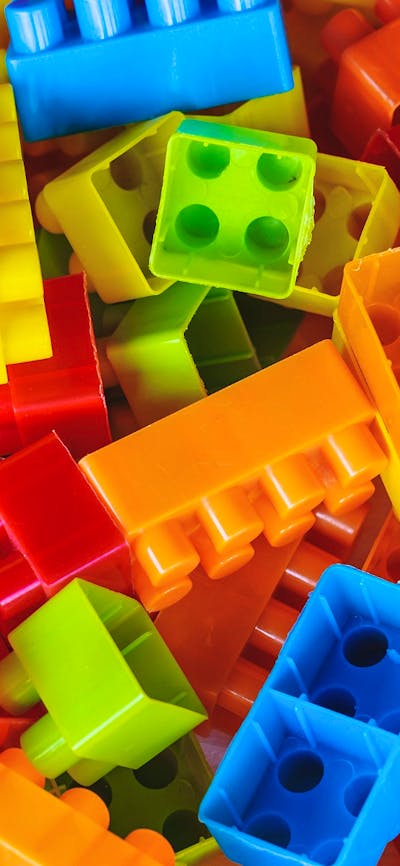 A pile of rainbow coloured building blocks