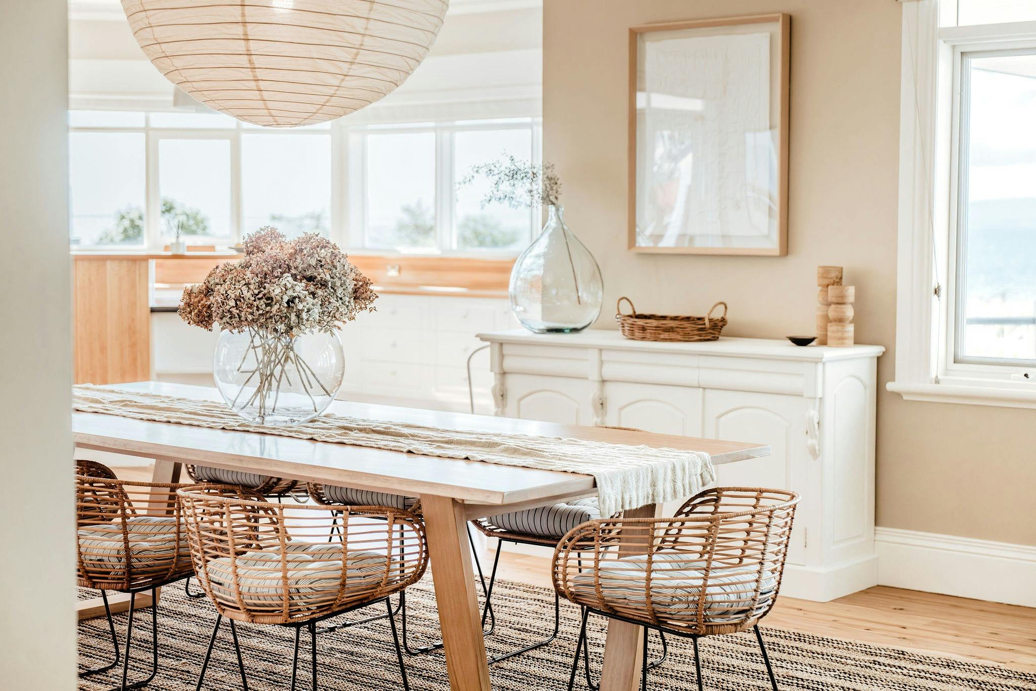 Dining room table, topped with a dried flower bouquet