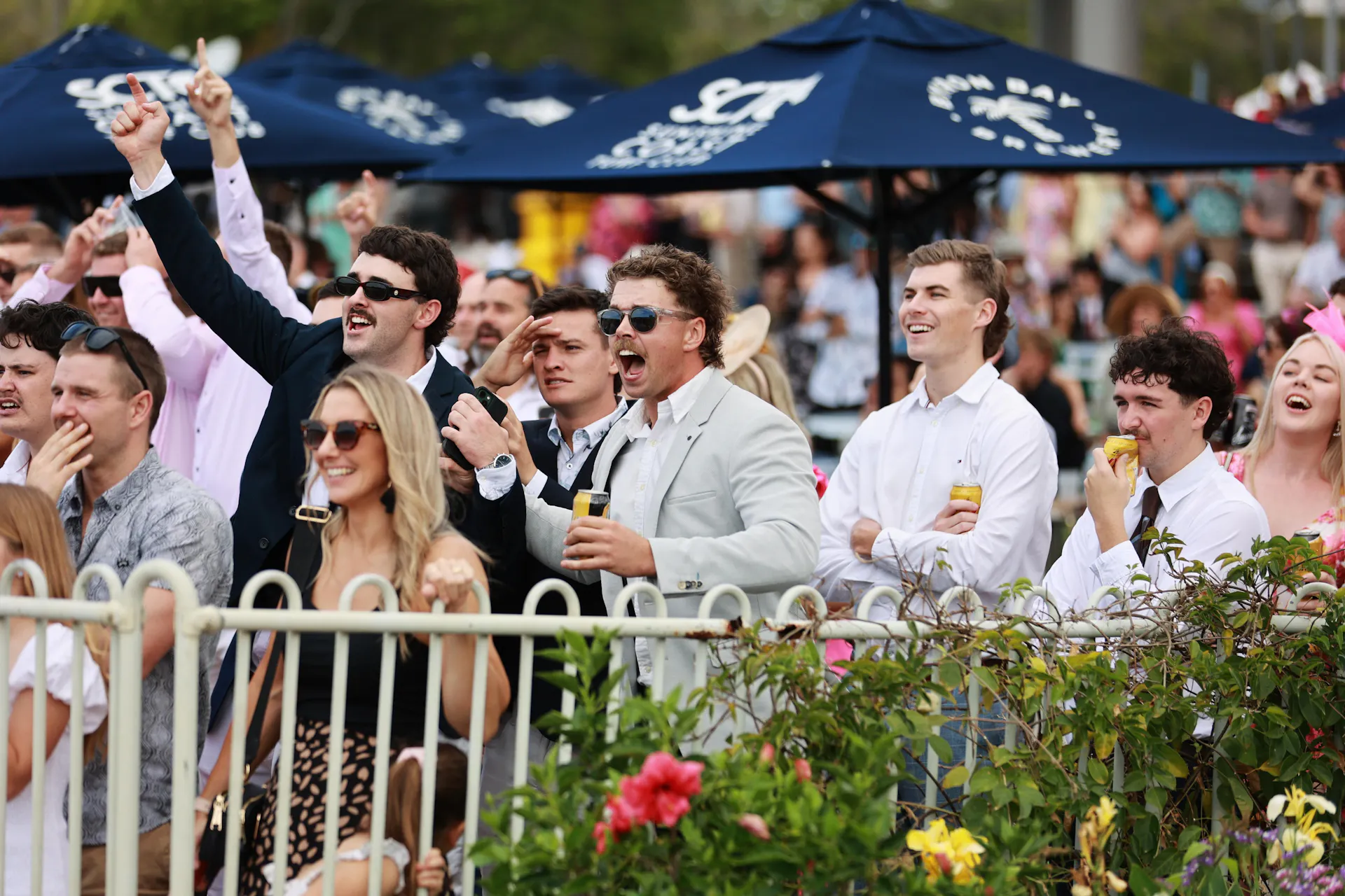 Group of people cheering watching the race