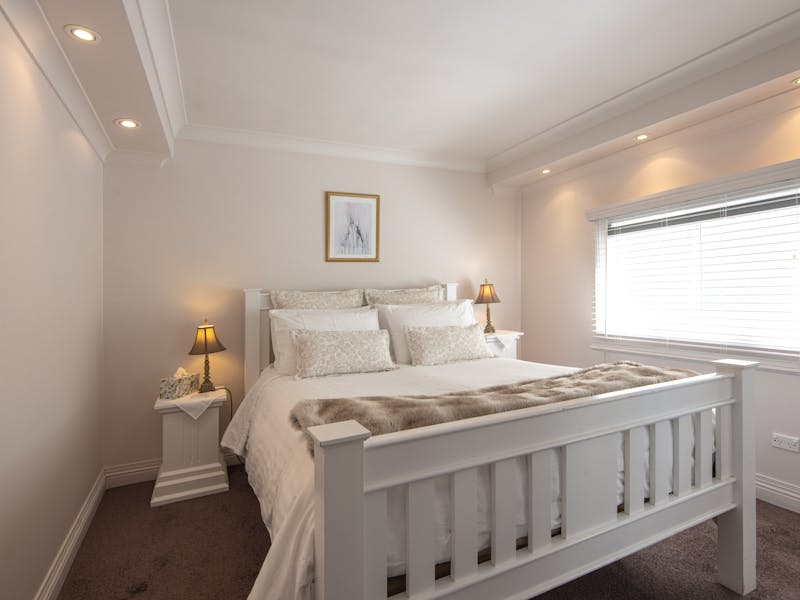Pillow top bed made up with top quality linen and variety of pillows.