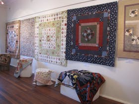 Quilts displayed on the wall