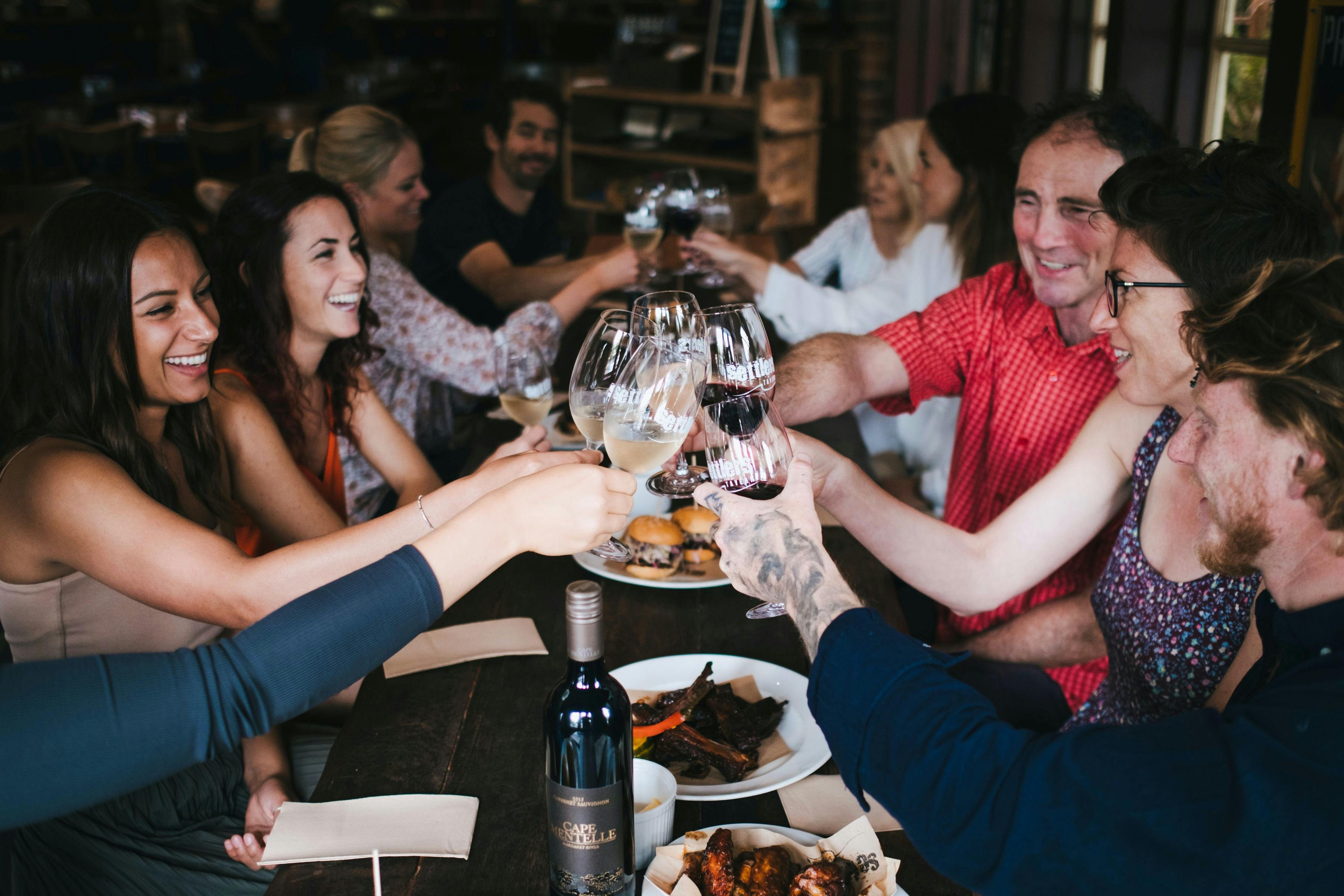 Tour guests raise their wine glasses during a seated lunch on tour