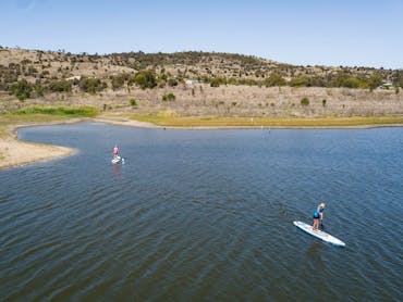 Two people Suping on Lake Callide Two people Suping on Lake Callide