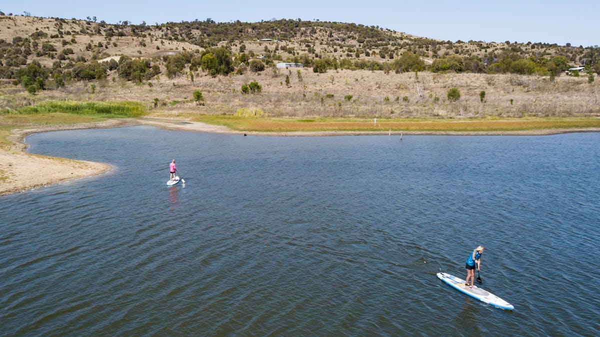 Two people Suping on Lake Callide
