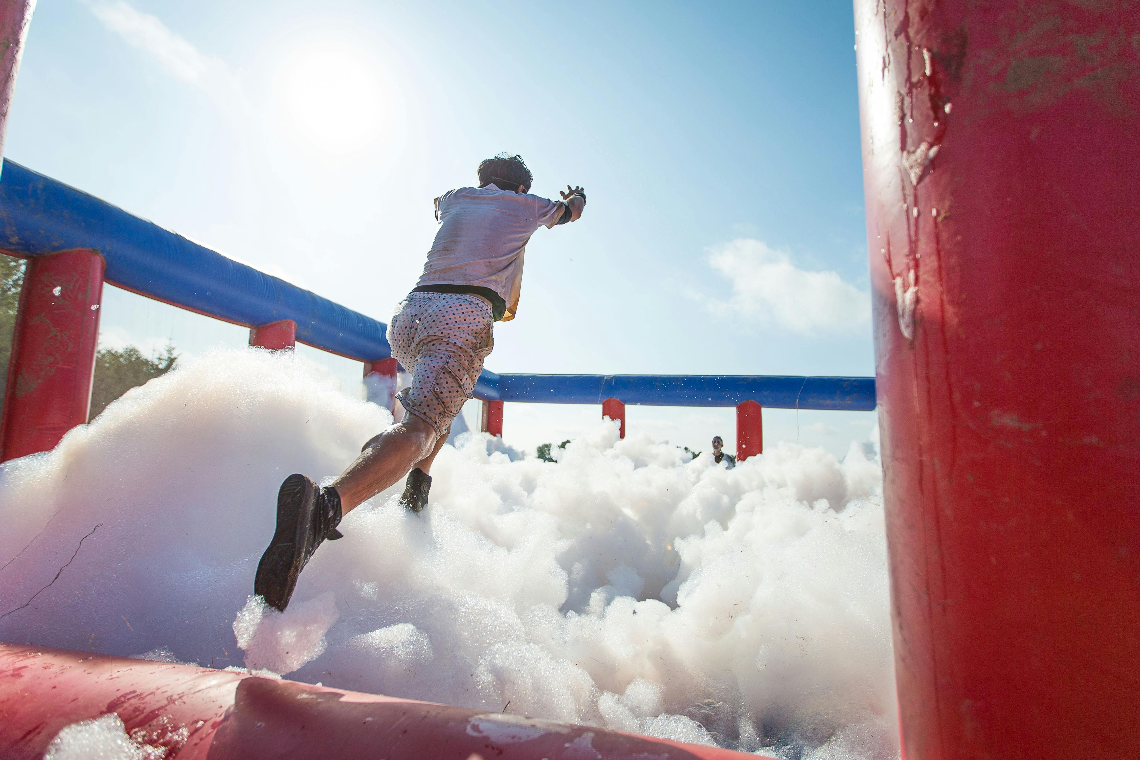 Man jumping into foam filled inflatable
