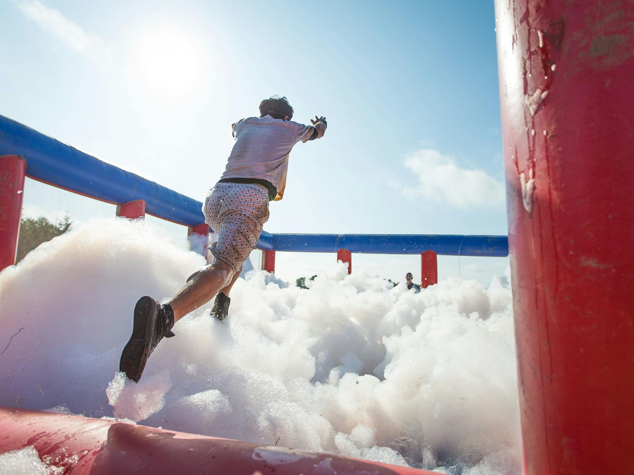 Man jumping into foam filled inflatable