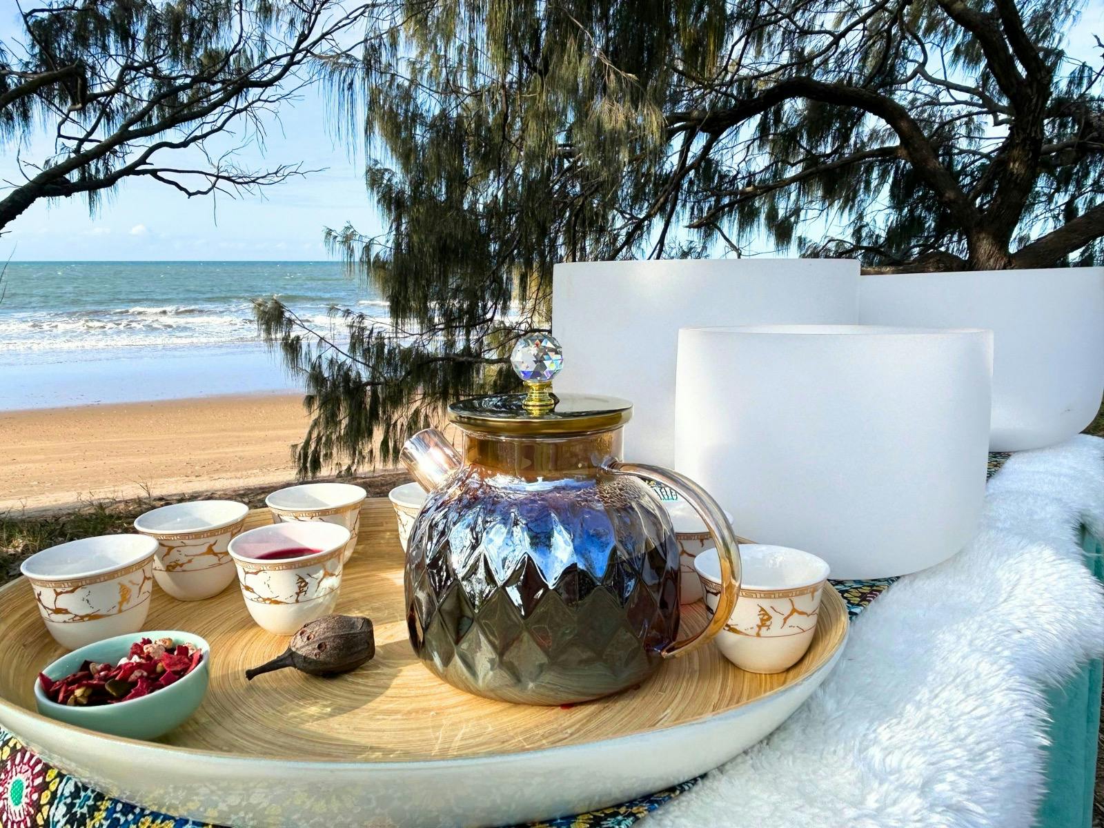 singing bowls on the beach with tea