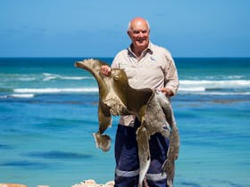 Uncle Ken holding locally foraged bull kelp on the Limestone Coast.