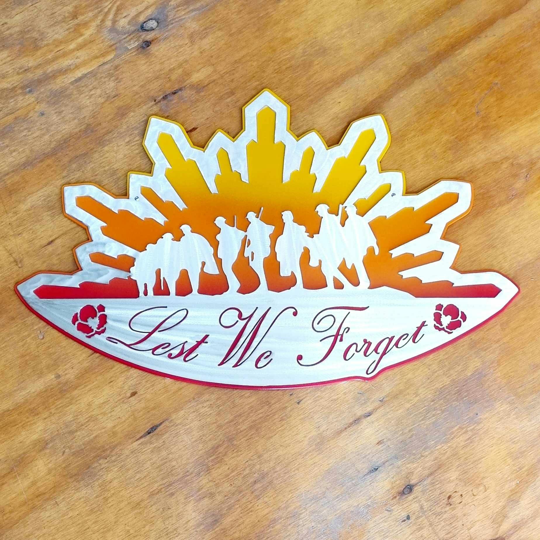 An artwork showing soldiers in a rising sun with the words lest we forget with poppies.