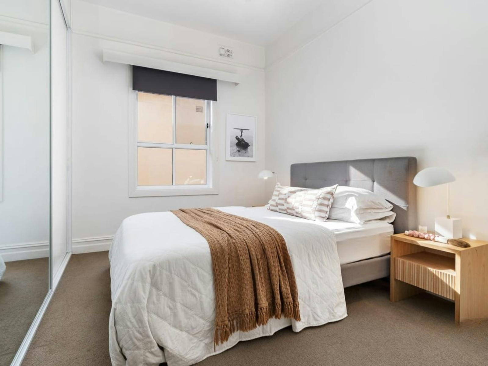 Queen bedroom with large mirrors and BIR