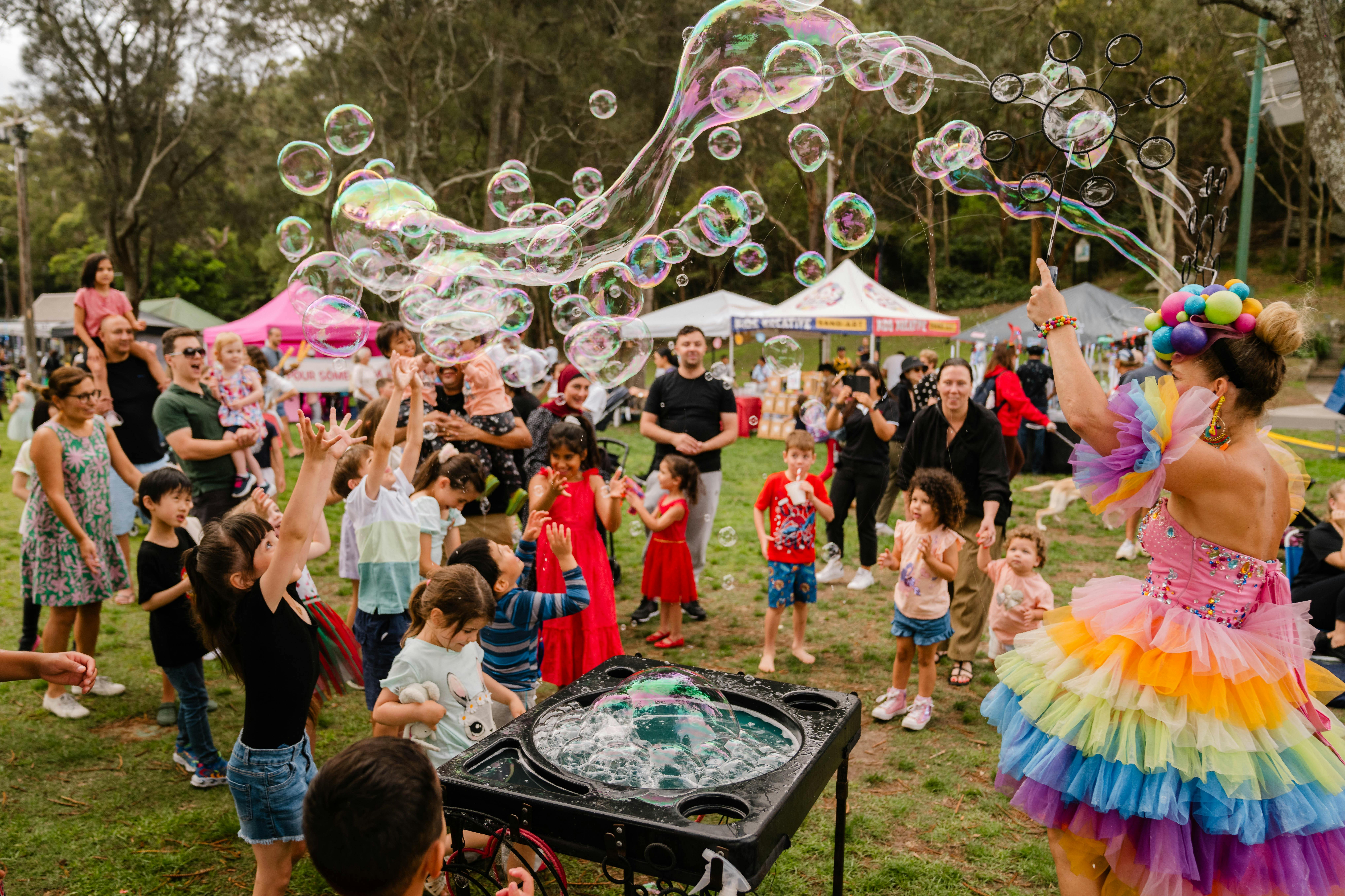 A crowd of people looking at bubbles